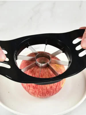 Person using an apple cutter to cut an apple into slices.